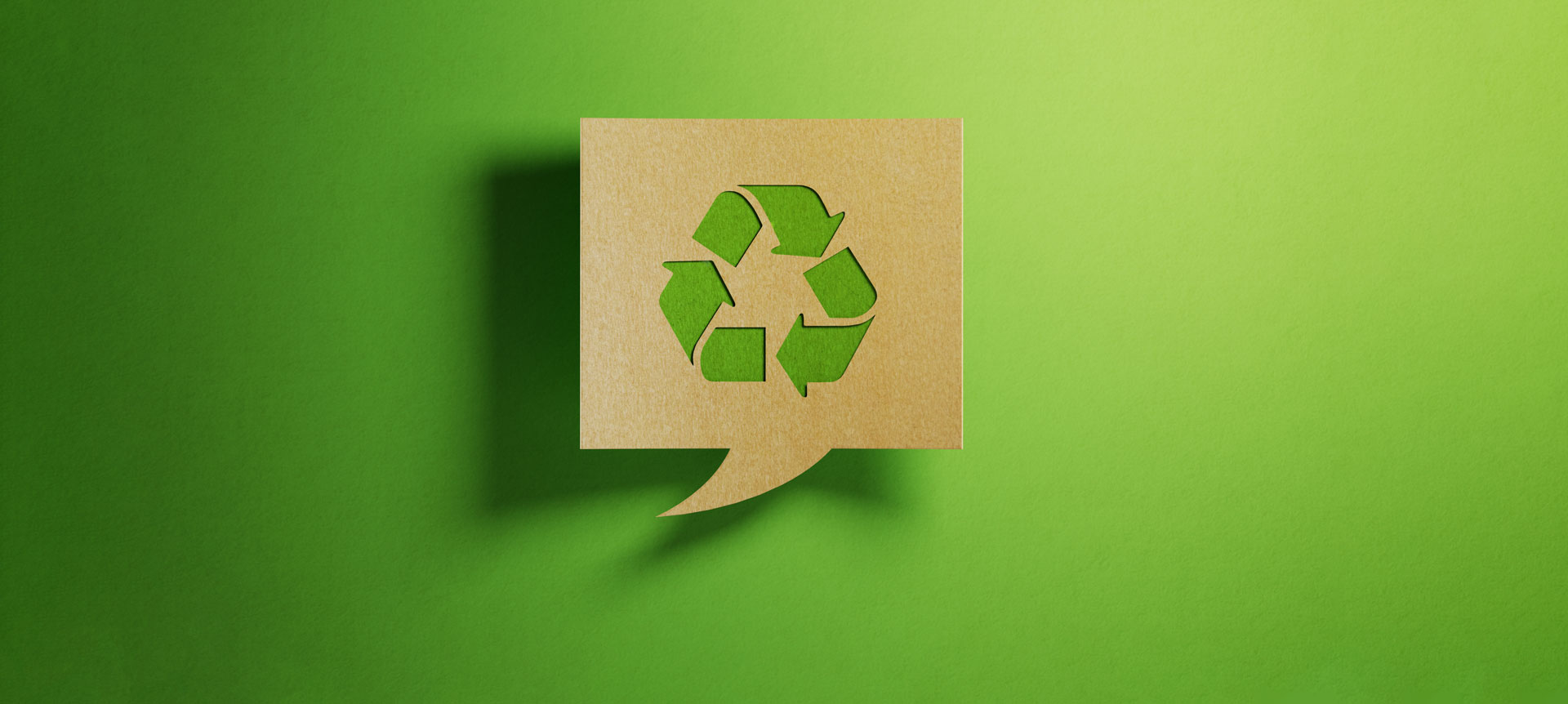 Chat Bubble Made of Recycled Paper on Green Background